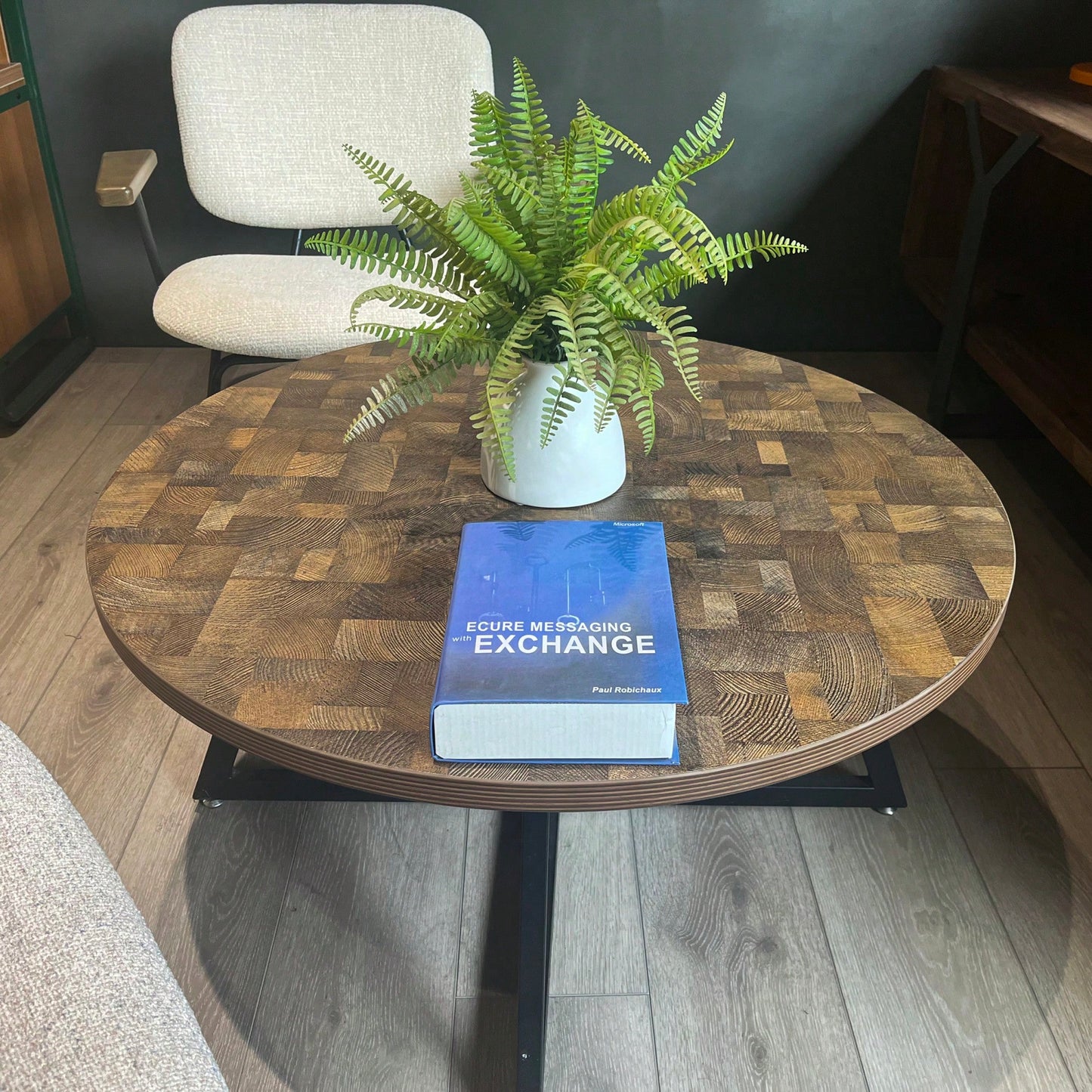 Round Coffee Table With Friendly Wood Grain Top And Sturdy Black Metal Frame For Modern Living Spaces