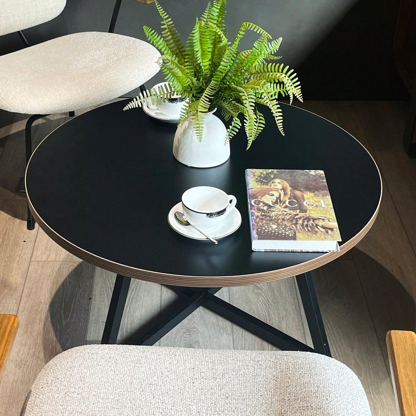 Round Coffee Table With Friendly Wood Grain Top And Sturdy Black Metal Frame For Modern Living Spaces