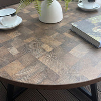 Round Coffee Table With Friendly Wood Grain Top And Sturdy Black Metal Frame For Modern Living Spaces