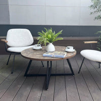 Round Coffee Table With Friendly Wood Grain Top And Sturdy Black Metal Frame For Modern Living Spaces