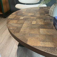 Round Coffee Table With Friendly Wood Grain Top And Sturdy Black Metal Frame For Modern Living Spaces