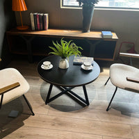 Round Coffee Table With Friendly Wood Grain Top And Sturdy Black Metal Frame For Modern Living Spaces